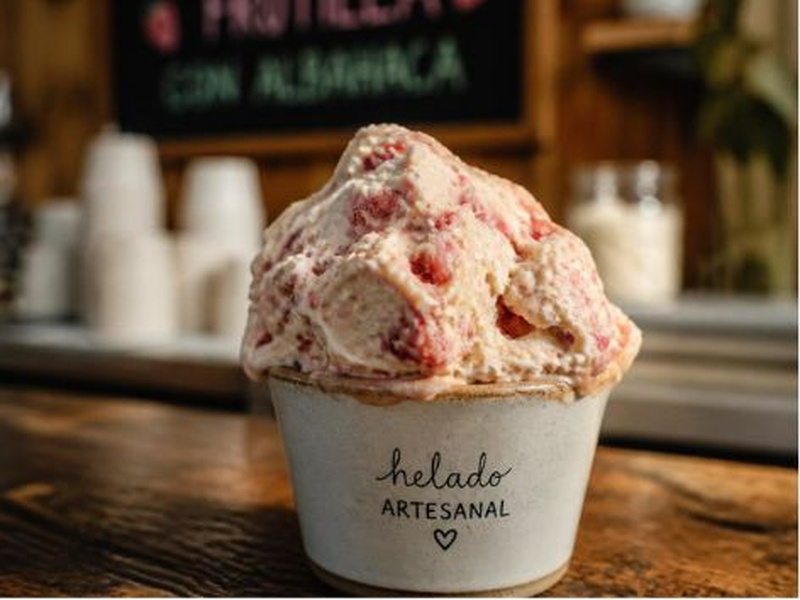 Dense scoop of helado artesanal showing real fruit texture